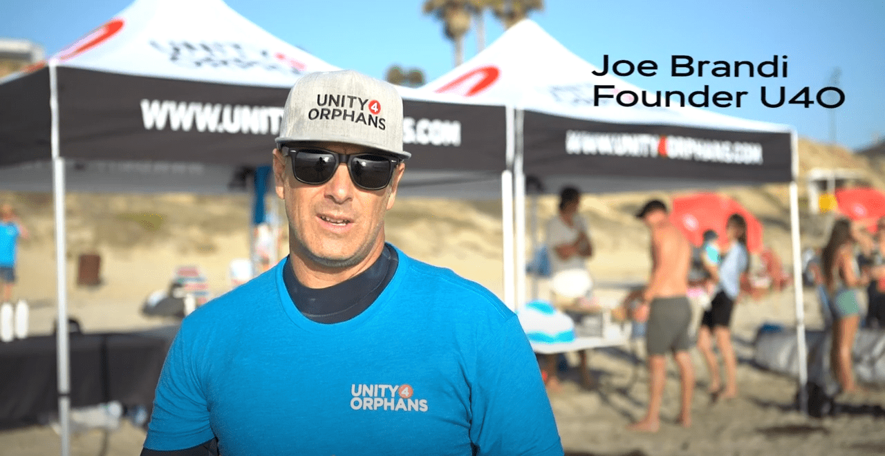 Joe Brandi thanks sponsors at Unity 4 Orphans 2022 Wave-A-Thon in San Diego