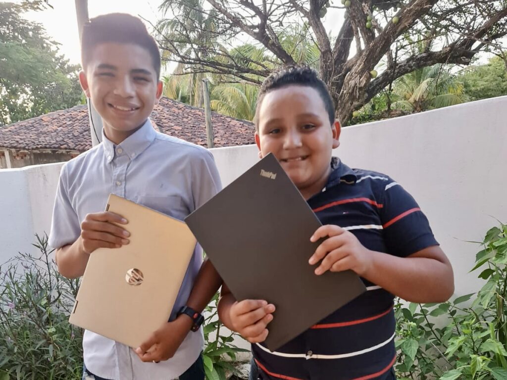 Students holding new learning laptops