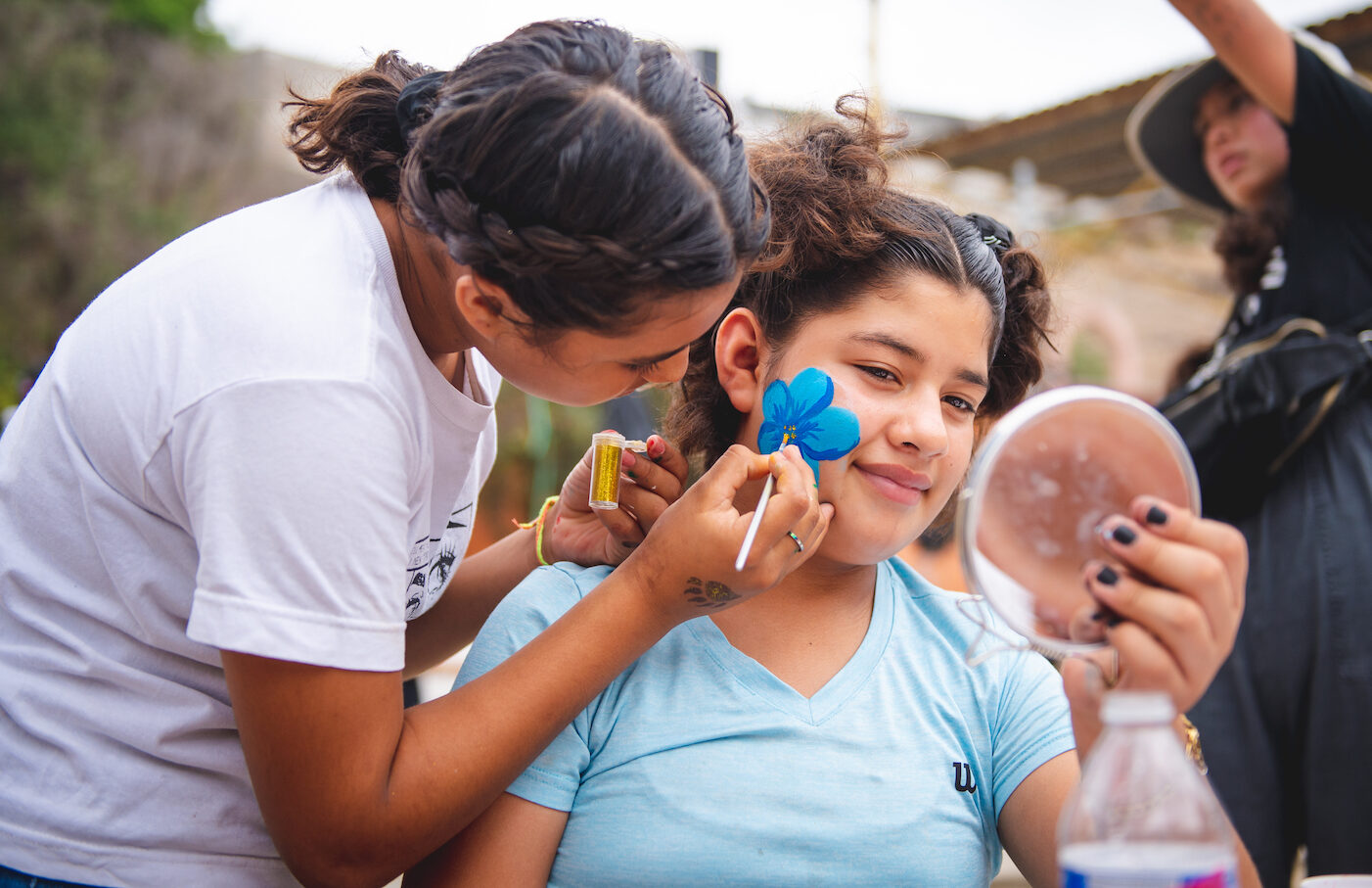 Girls face painting with supplies donated by San Diego charity Unity 4 Orphans