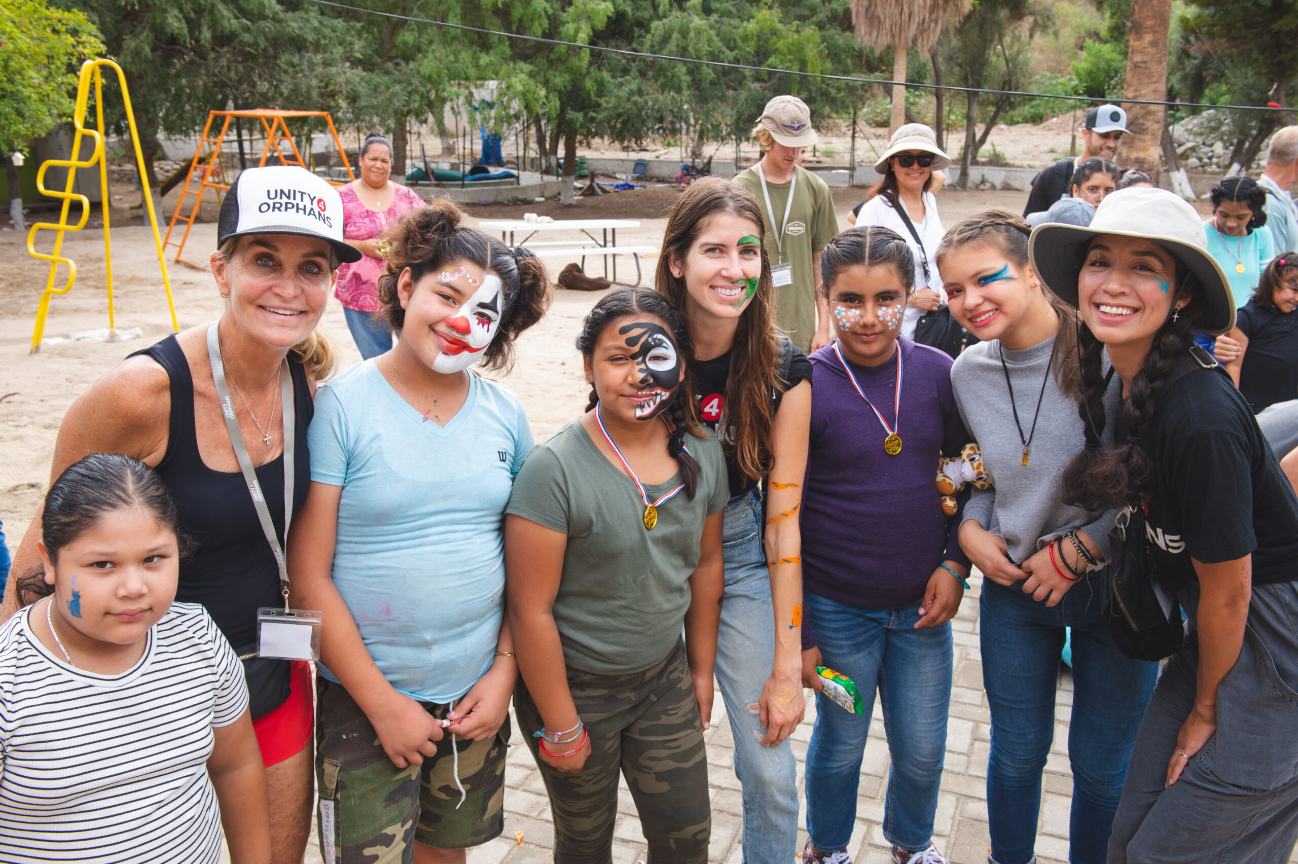 San Diego charity Unity 4 Orphans staff with children who have their faces painted