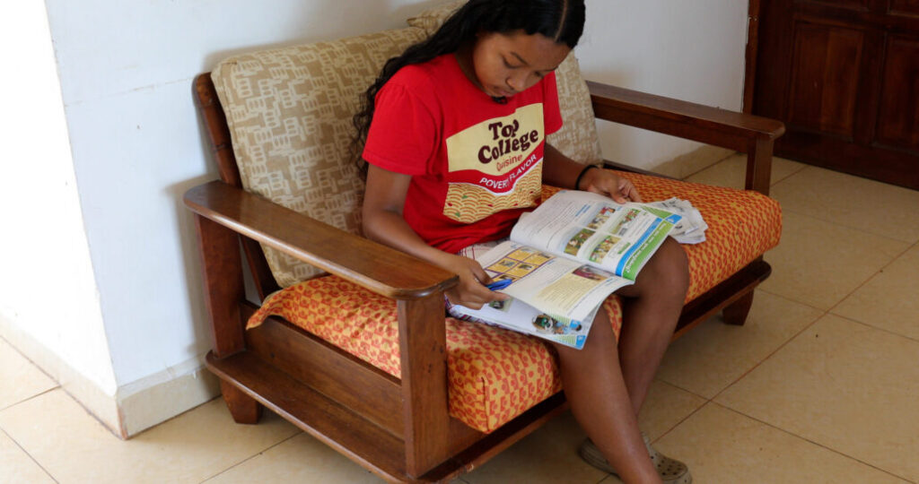 a student reading a book in English as a part of San Diego charity Unity 4 Orphans’ ESL program in Nicaragua