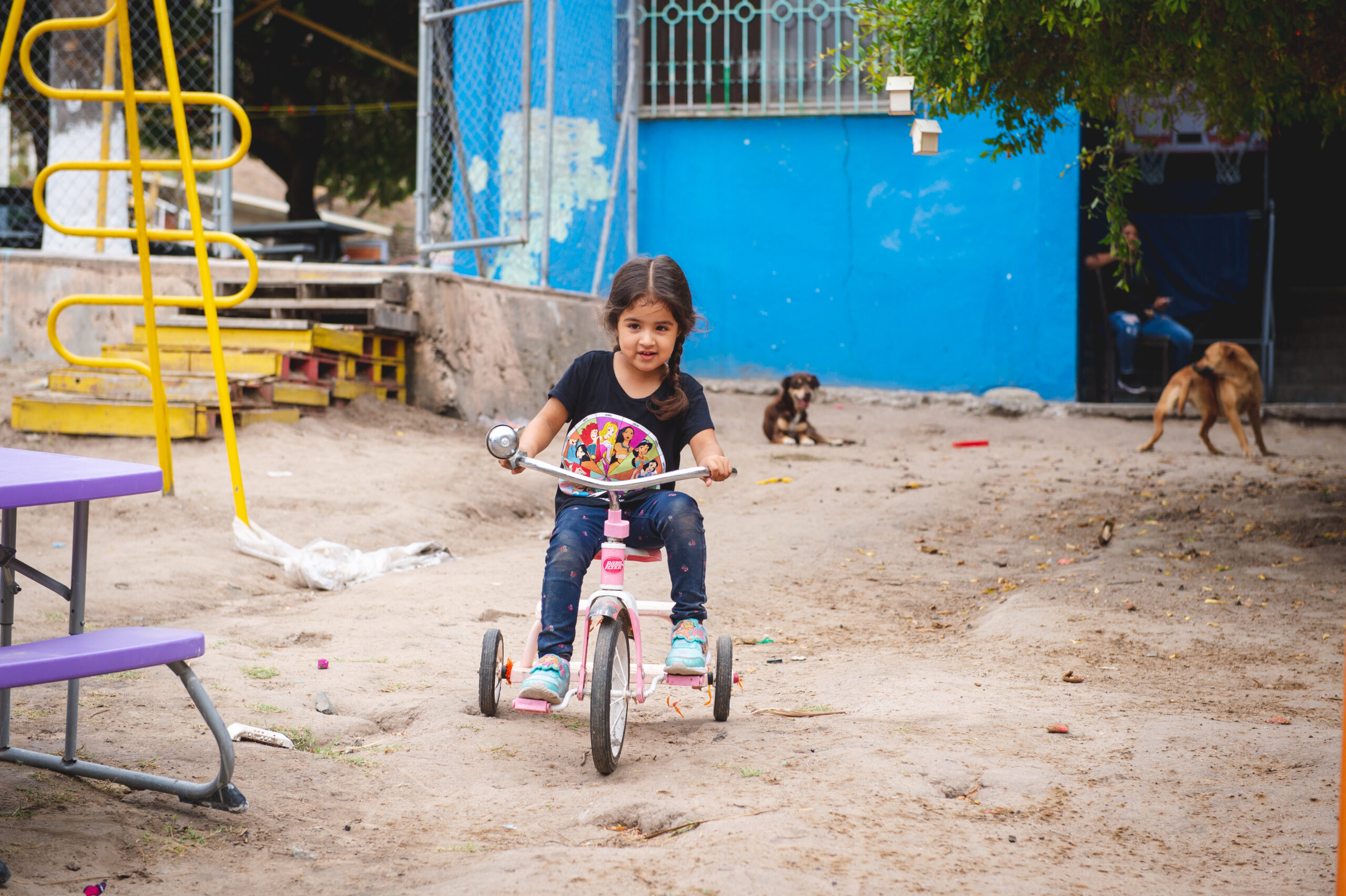a child riding a tricycle with Unity 4 Orphans' program in Mexico