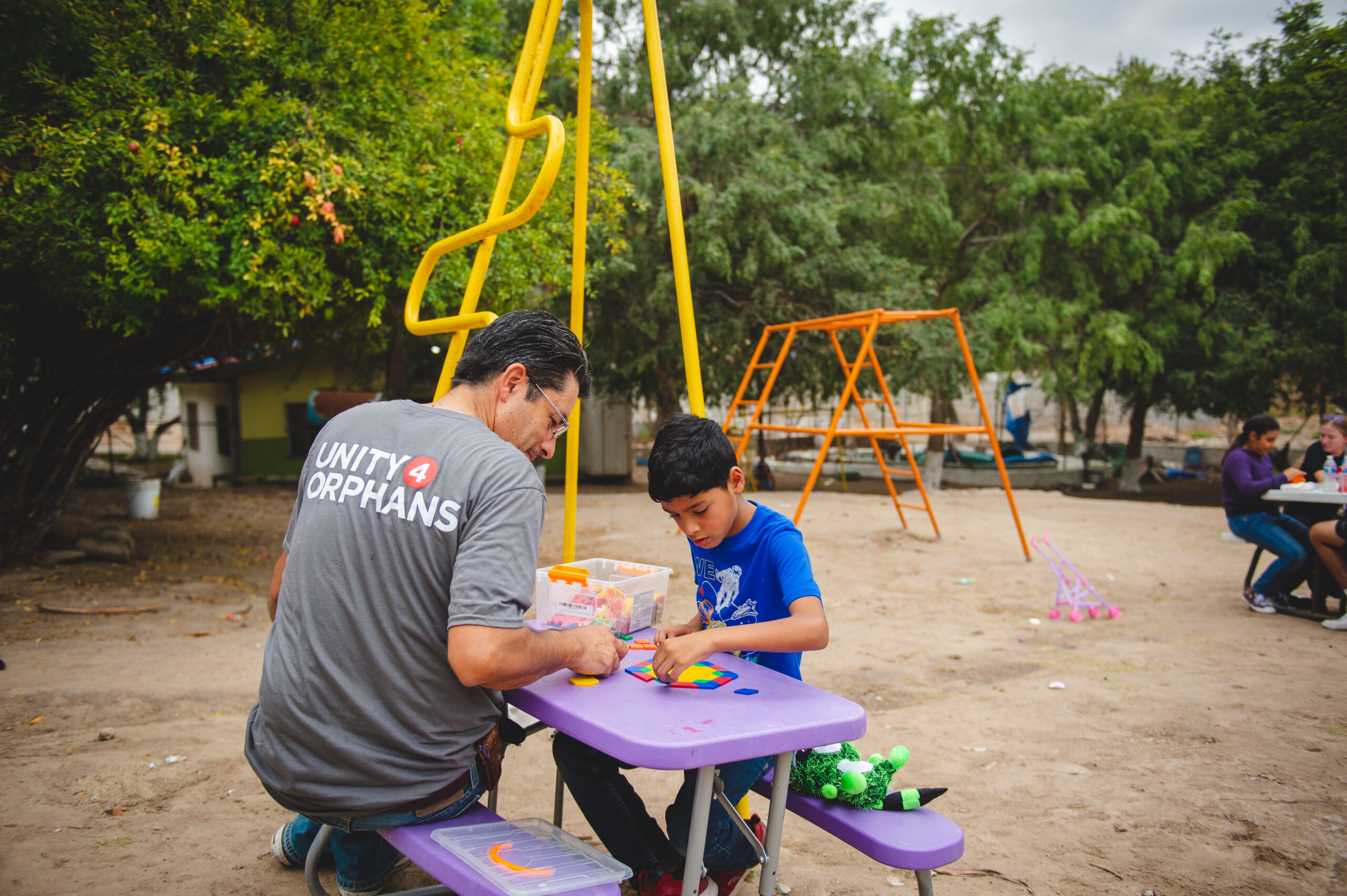 Unity 4 Orphans volunteer playing with a child at an orphanage in Mexico