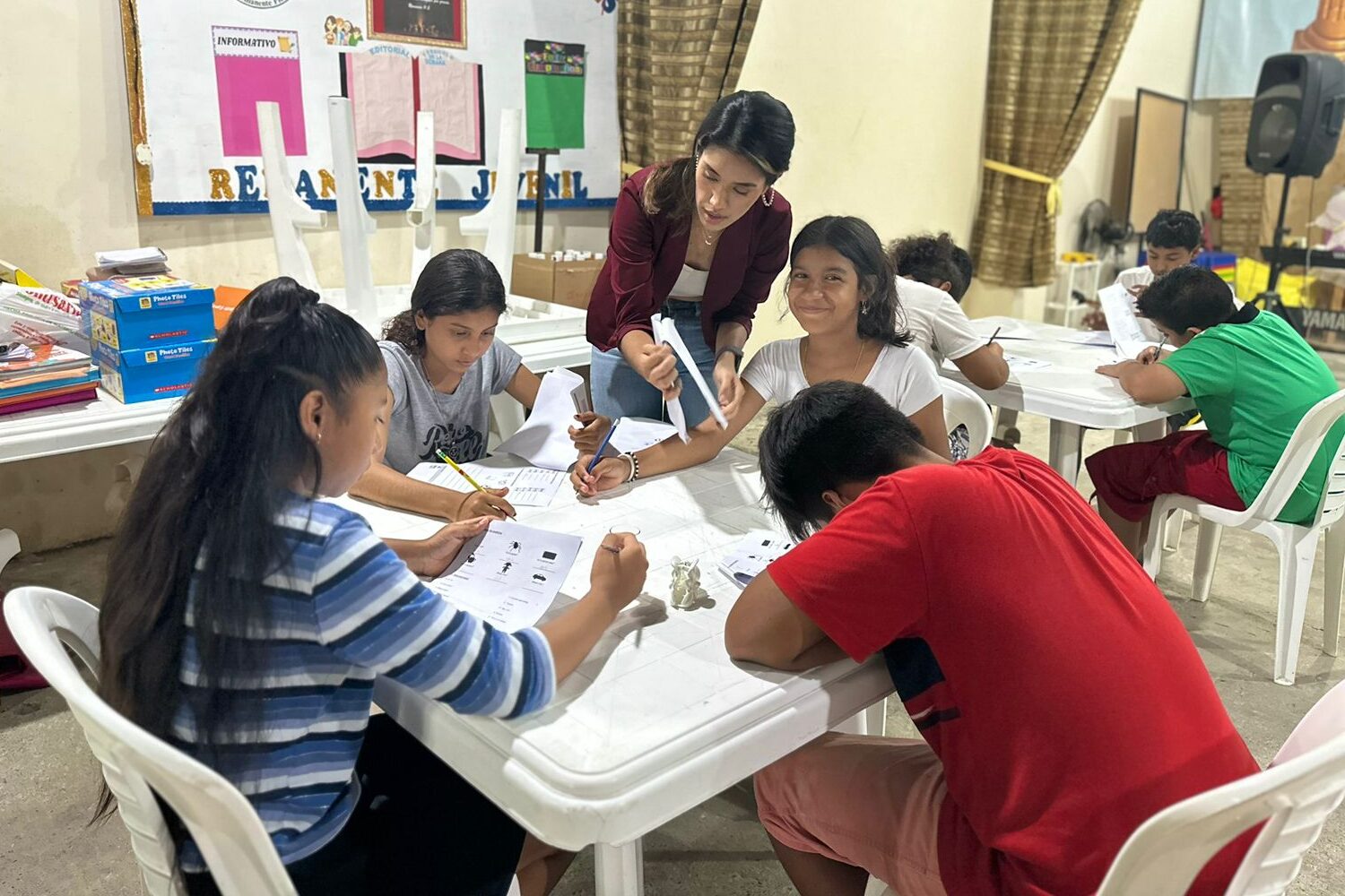 a local volunteer helping ESL students in class