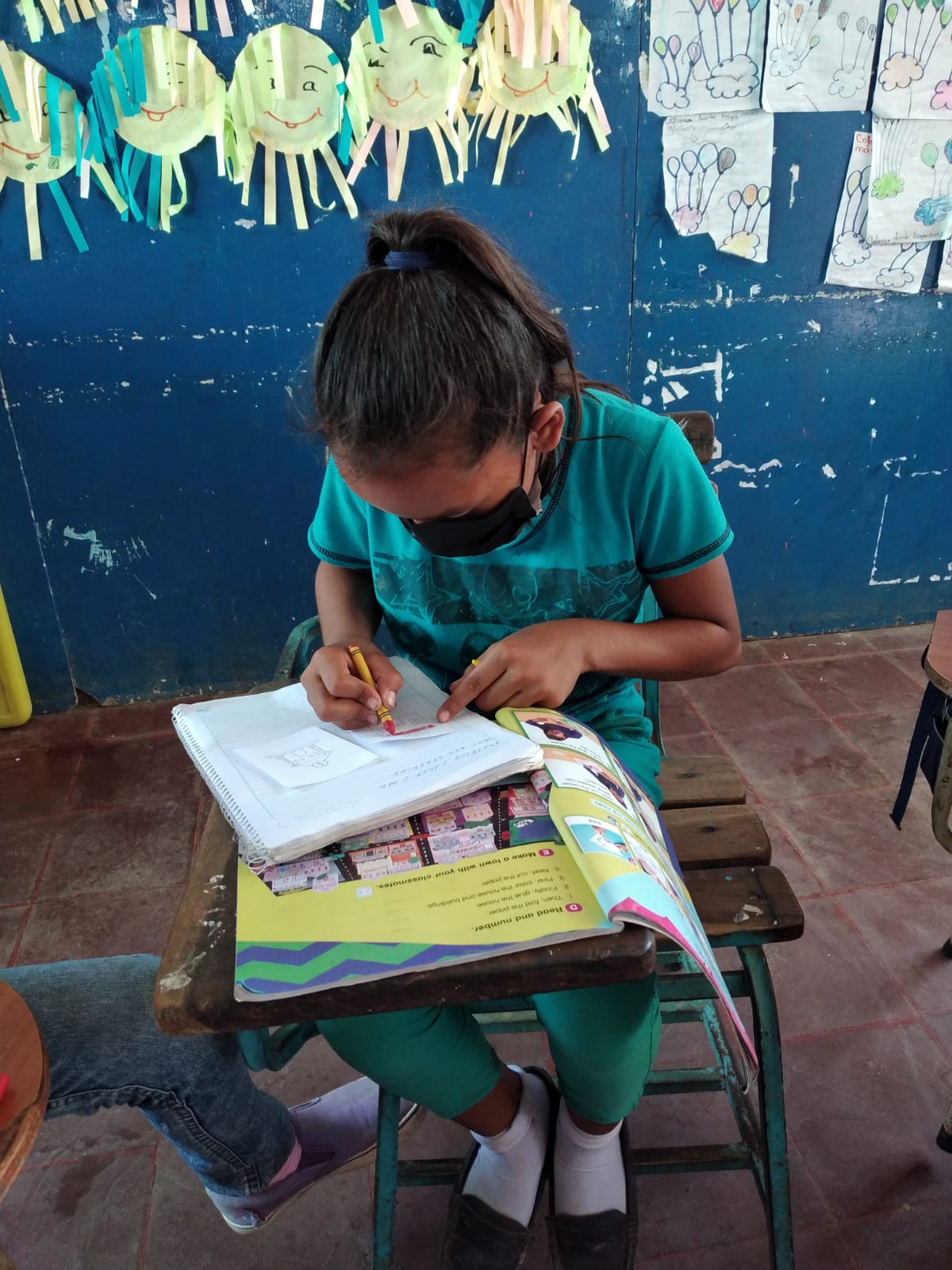 an ESL student at an orphanage working on English homework 