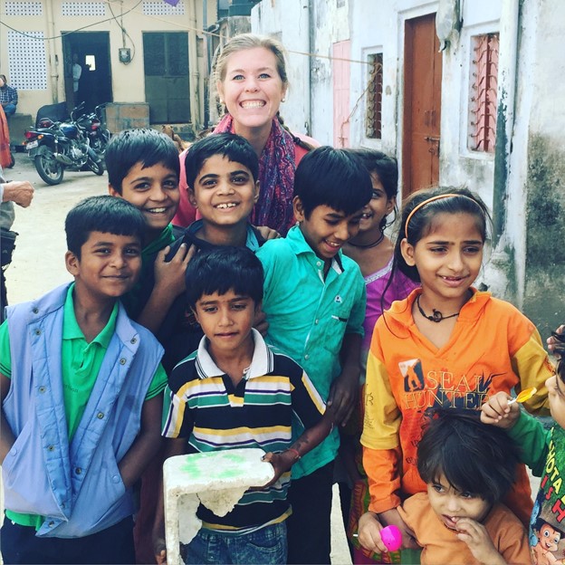 U4O’s newest team member, Caitlin Snyder, standing with a group of children in need