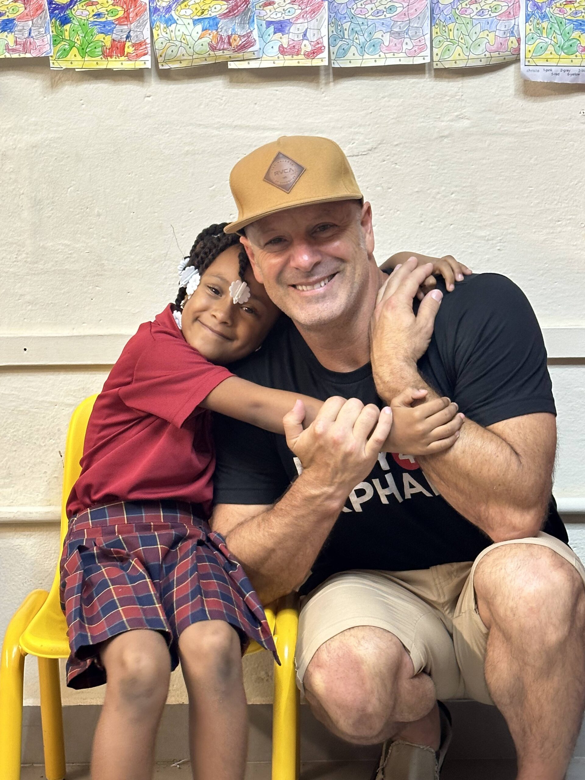 U4O founder Joe Brandi hugging a vulnerable child while they’re both smiling.